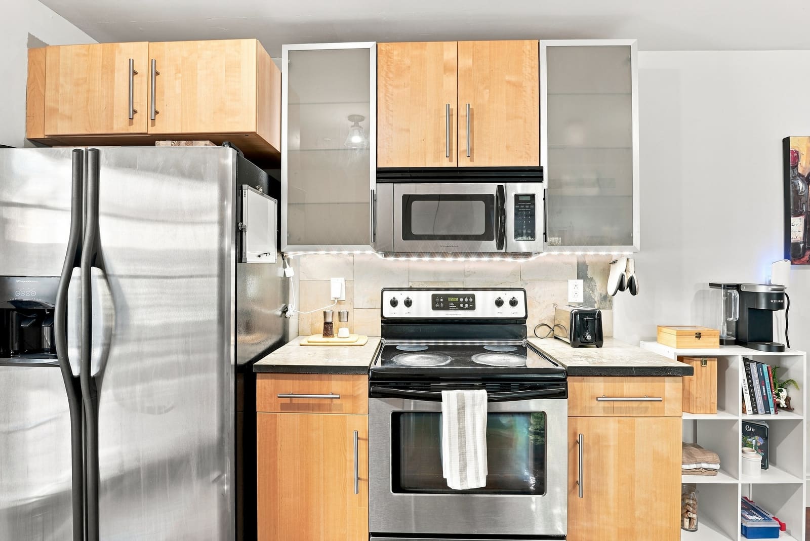 Kitchen with refrigerator, stove, microwave and coffee maker