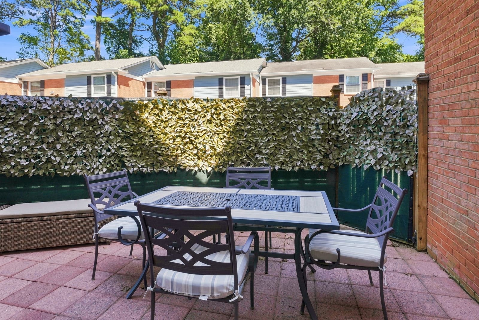 Private brick patio with a table and chairs